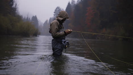 fly fishing in a misty autumn forest river