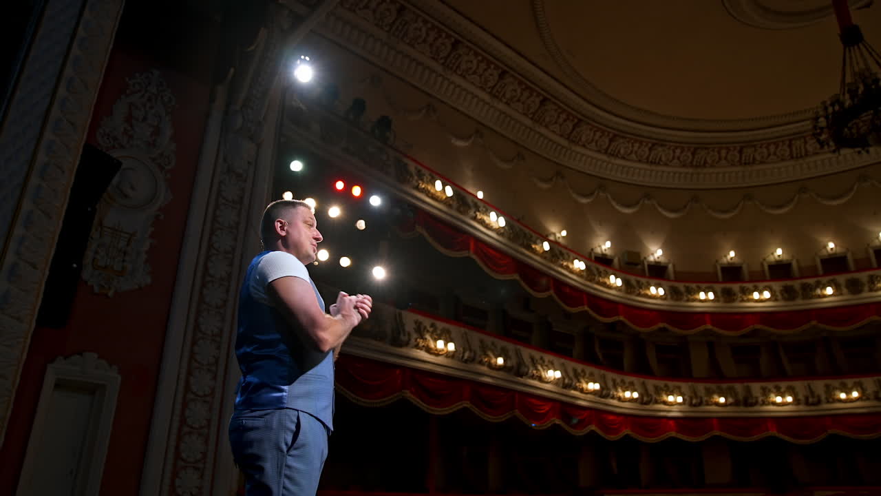 Young actor performing a monologue in a theater. Showman.