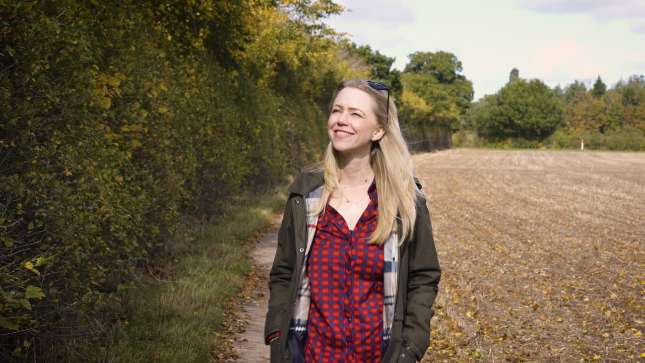 Woman Walking on a Path in Autumn