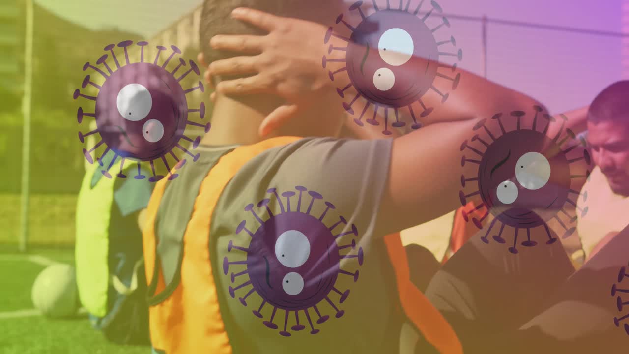 animación de células de covid 19 sobre jugadores de fútbol que se calientan en el campo