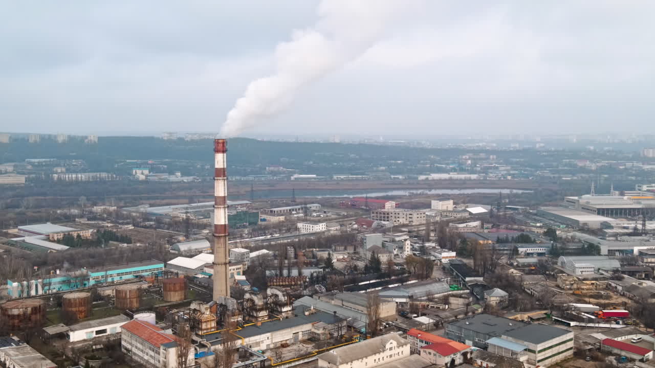 Cityscape of Chisinau from a drone at cloudy weather, thermal station with smoke getting out, buildings and bare trees in Moldova