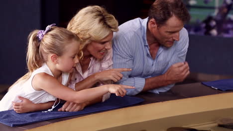 Happy-family-looking-at-fish-in-the-tank