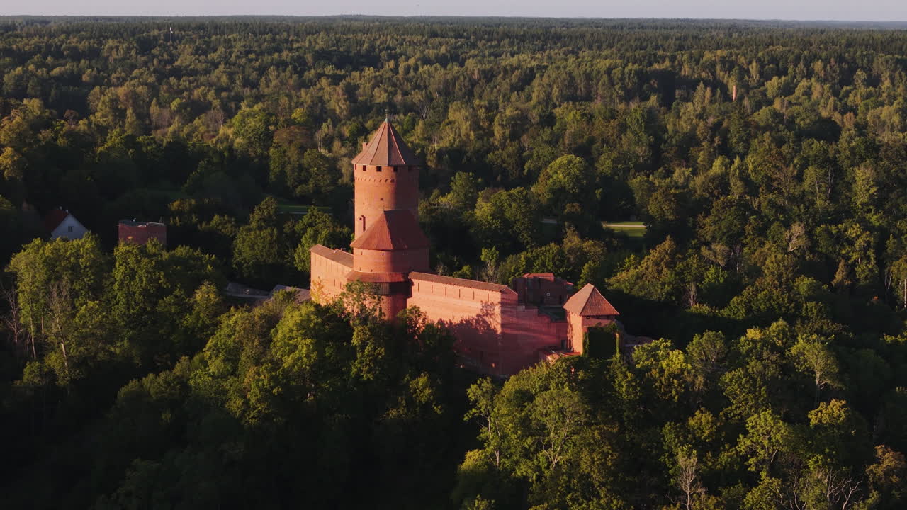 Aerial Shot Of Turaida Castle Nestled In The Heavily Wooded Forest Landscape Of Sigulda, Latvia.