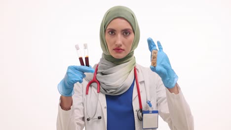 doctor holding hpv blocks and blood test tubes