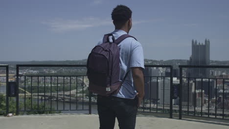 african american traveller approaches a scenic overlook and takes in the view stabilized shot in uhd 4k