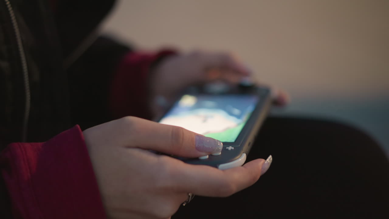 Casual Play With Mobile Puzzle In Evening, Person Using Touch Screen Puzzle With Painted Nails At Night, Quiet Evening Activity Involving Finger Taps On Mobile Device With Gentle Illumination