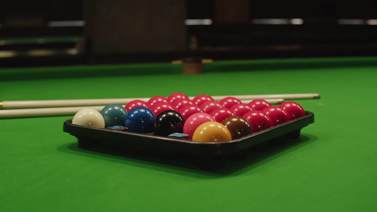 Snooker colorful balls close-up on green billiards table for start to play. Snooker game. Billiard balls with numbers on a pool table. Billiards team sport.High quality 4k footage