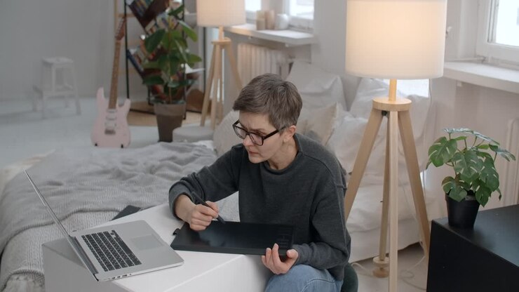 Woman working on a digital tablet in a home office