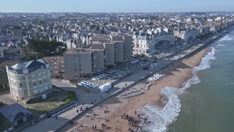 people walking along digue de rochebonne, saint-malo in brittany, france