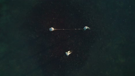 monument of three fishermen of búzios, aerial and overhead pull away shot