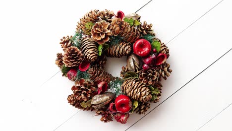 christmas wreath on white wooden background