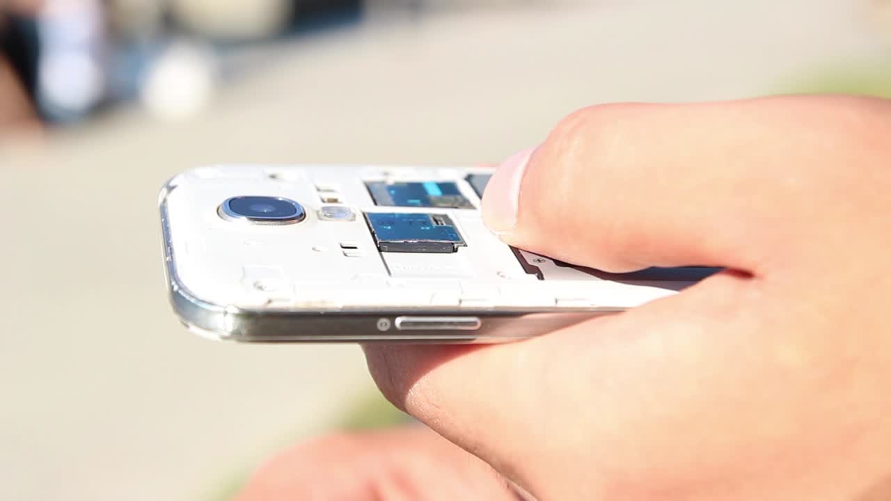 Young Man Checking Smartphone Memory Card Close Up Shoot