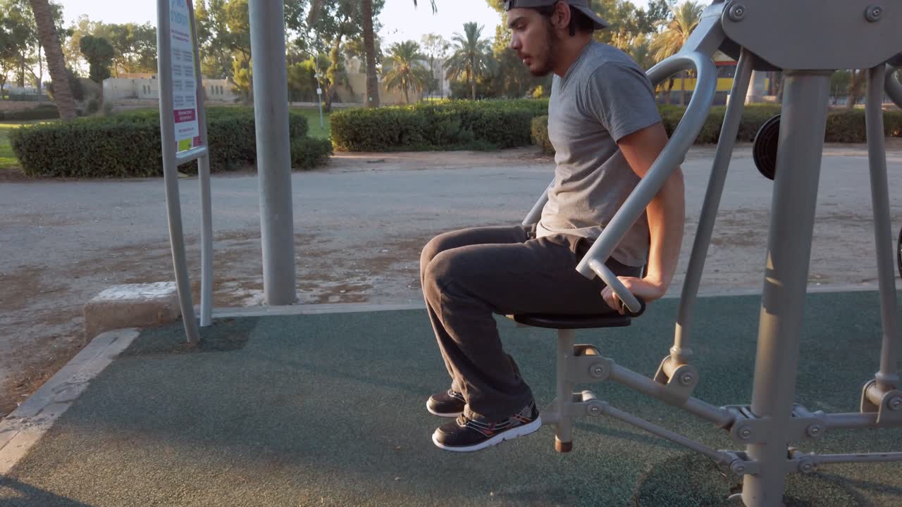 young man, lift your own weight in fitness equipment.