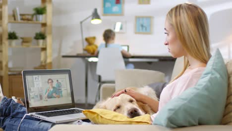 woman with sleepy dog video calling vet