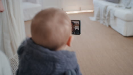 mother and baby using smartphone having video chat with friends waving at toddler mom sharing motherhood lifestyle having conversation on mobile phone