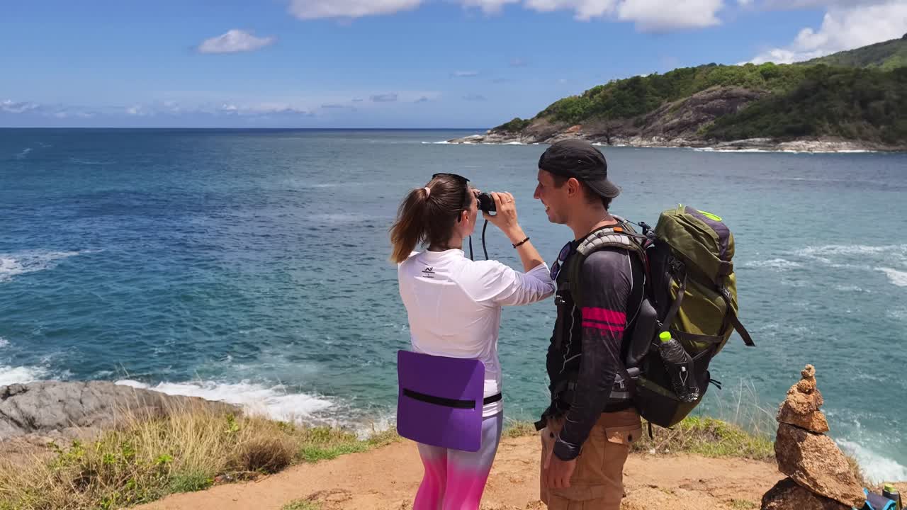 Couple Hiking and Enjoying the Scenic Ocean View
