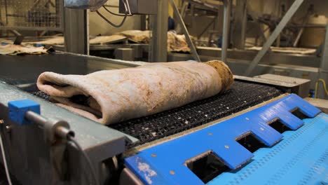 Leather-being-transported-on-a-conveyor-belt-inside-a-factory