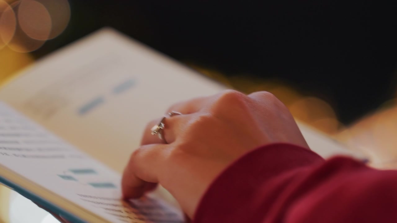 Calm evening with gentle reading. Tranquil nighttime scene with slow page turns under gentle glow. Serene evening atmosphere depicted through quiet pages flipping under soft lighting conditions