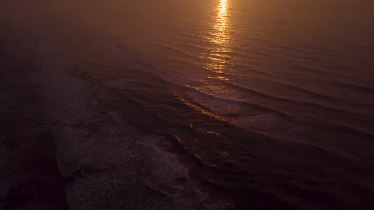 tomas aéreas de la playa al atardecer, hermoso cielo y olas