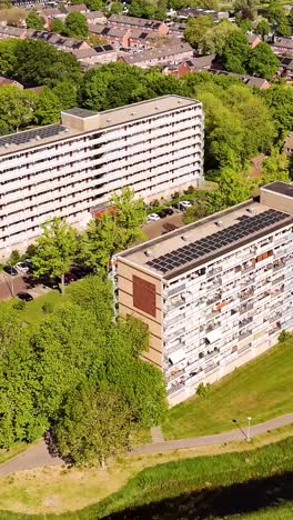 aerial view of apartment buildings with solar panels and green spaces