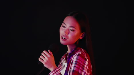 woman singing into a microphone