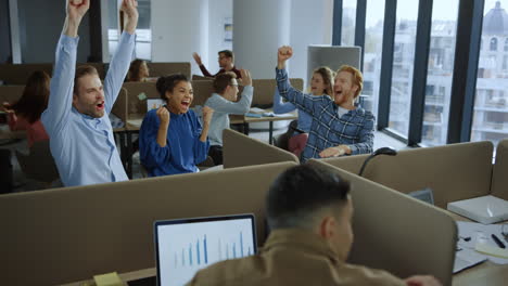 Business-team-celebrating-success-in-office.-Colleagues-giving-high-five