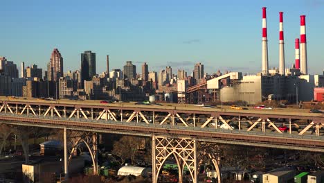 traffic moves across the queensboro bridge with the new york skyline background 1