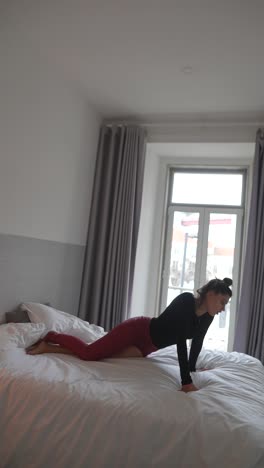 Woman practicing yoga and resting in bed