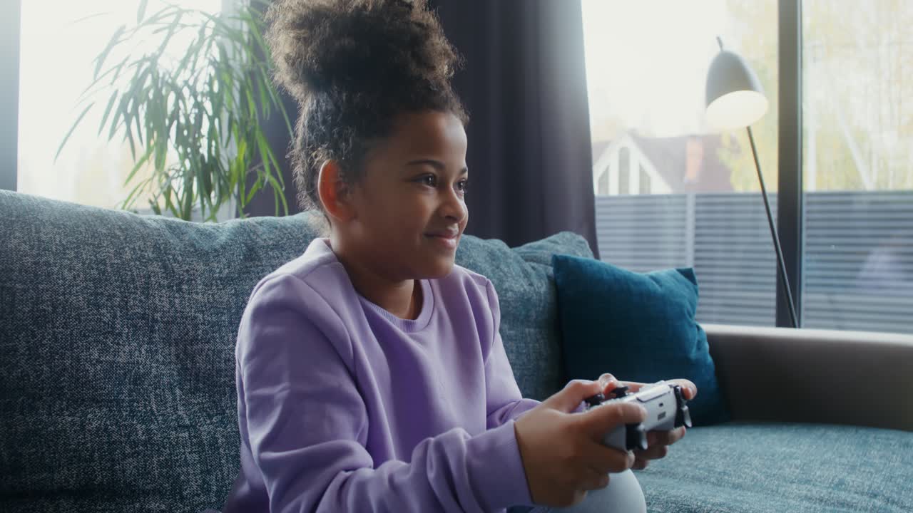 Girl playing video games at home