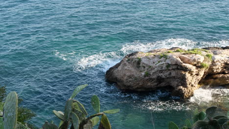 Stunning-seascape-ocean-waves-on-rock-during-golden-hour