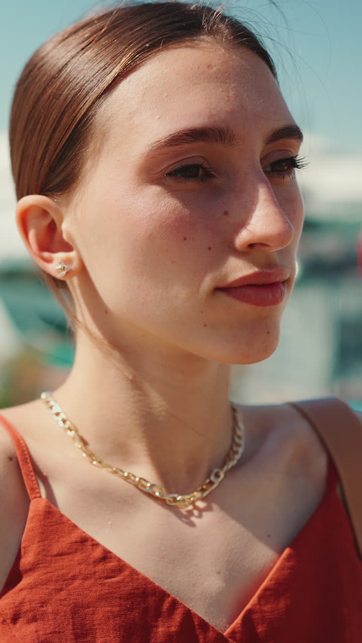 Portrait of a woman wearing a gold necklace