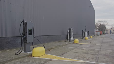 dolly out of several electric vehicle charging stations on an industrial parking lot