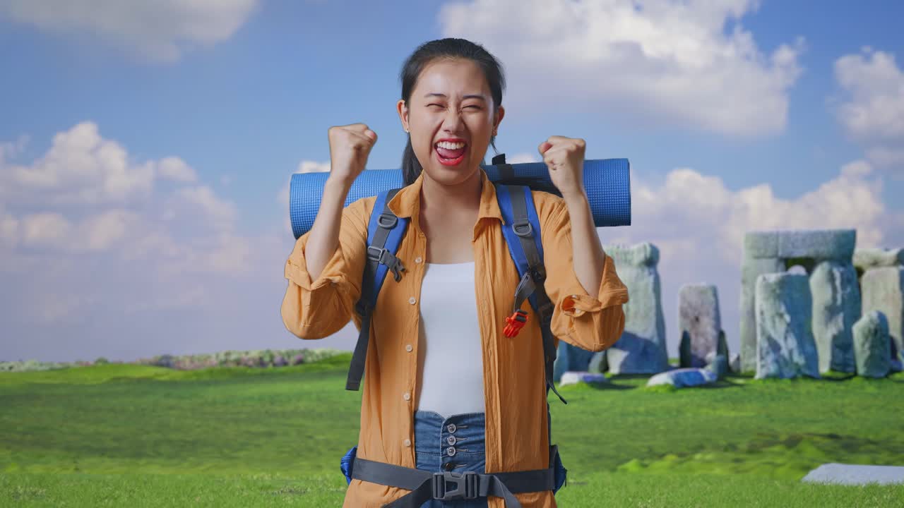 Asian Female Hiker With Mountaineering Backpack Screaming Goal Celebrating The Success While Traveling In Stonehenge