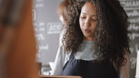 happy barista woman serving customer paying using credit card contactless payment spending money buying coffee in cafe