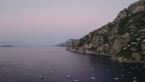 tranquil view of recreational boats at amalfi coast near positano village in southern italy