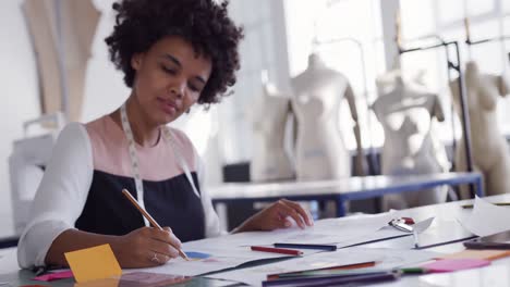 mixed race woman working in fashion office