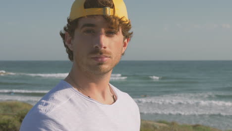 portrait of athlete man with cap looking at camera