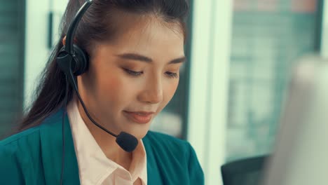 businesswoman wearing headset working actively in office