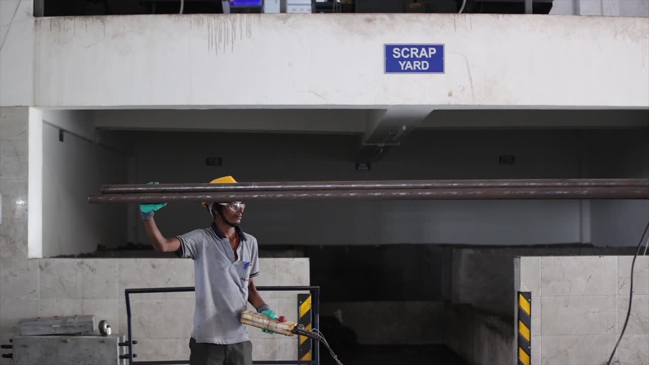 worker working metal raw metal rod and truck is unload.