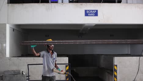 worker working metal raw metal rod and truck is unload.