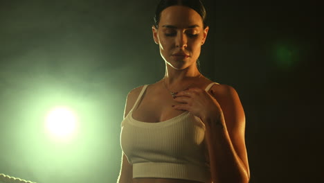 confident female boxer in a studio setting