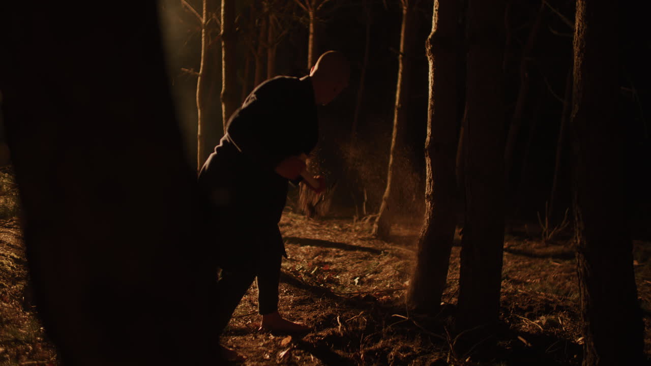 Man working in the dark forest at night