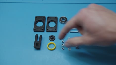 picking parts prepared for assembly on blue table