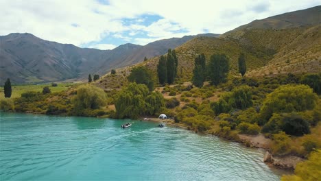 aerial fly over of beautiful lake benmore with its turquoise water in new zealand - dolly shot