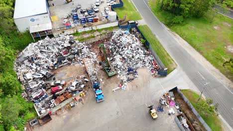 scrapyard operations with machinery and metal piles