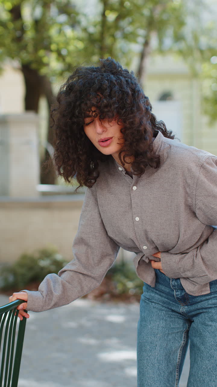 Woman tourist feeling sudden strong abdominal stomach ache diarrhea gastritis problem on city street