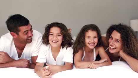 Cute-family-laughing-on-their-bed