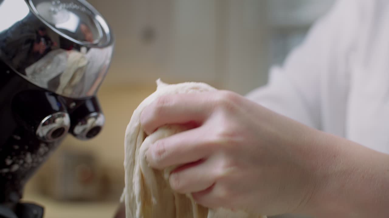 Pulling pizza dough out of a stand mixer