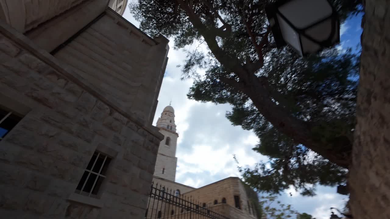 Worm's-eye view hyperlapse looking up at the grand tower of the Dormition Abbey in Jerusalem