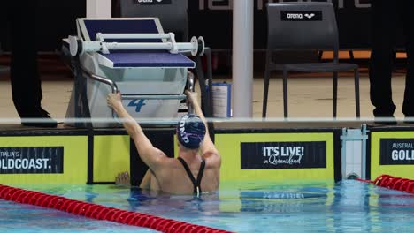 sequence of a swimmer starting a race in a pool